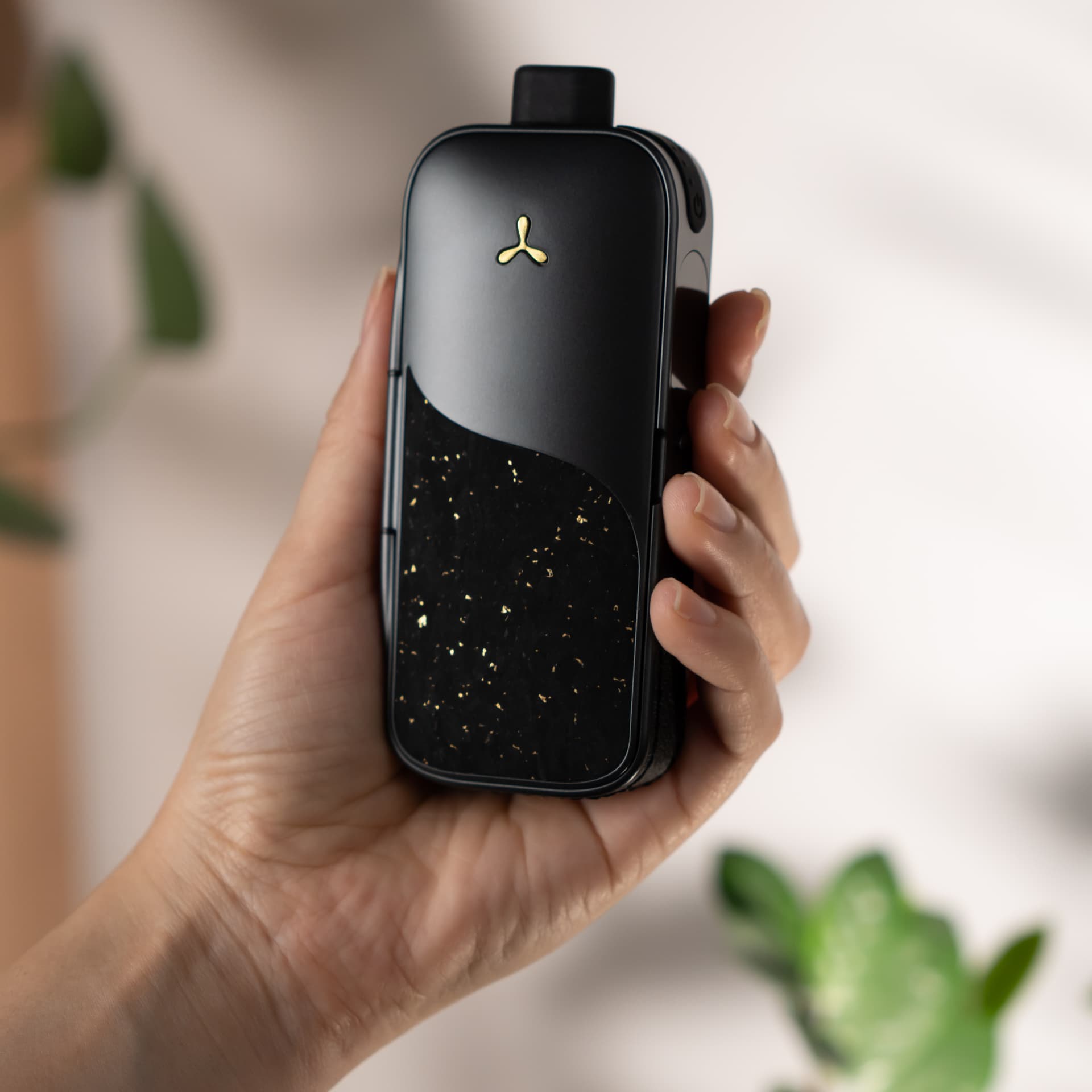 AirVape Legacy Pro 2 held in hand showing compact portable size and cork texture