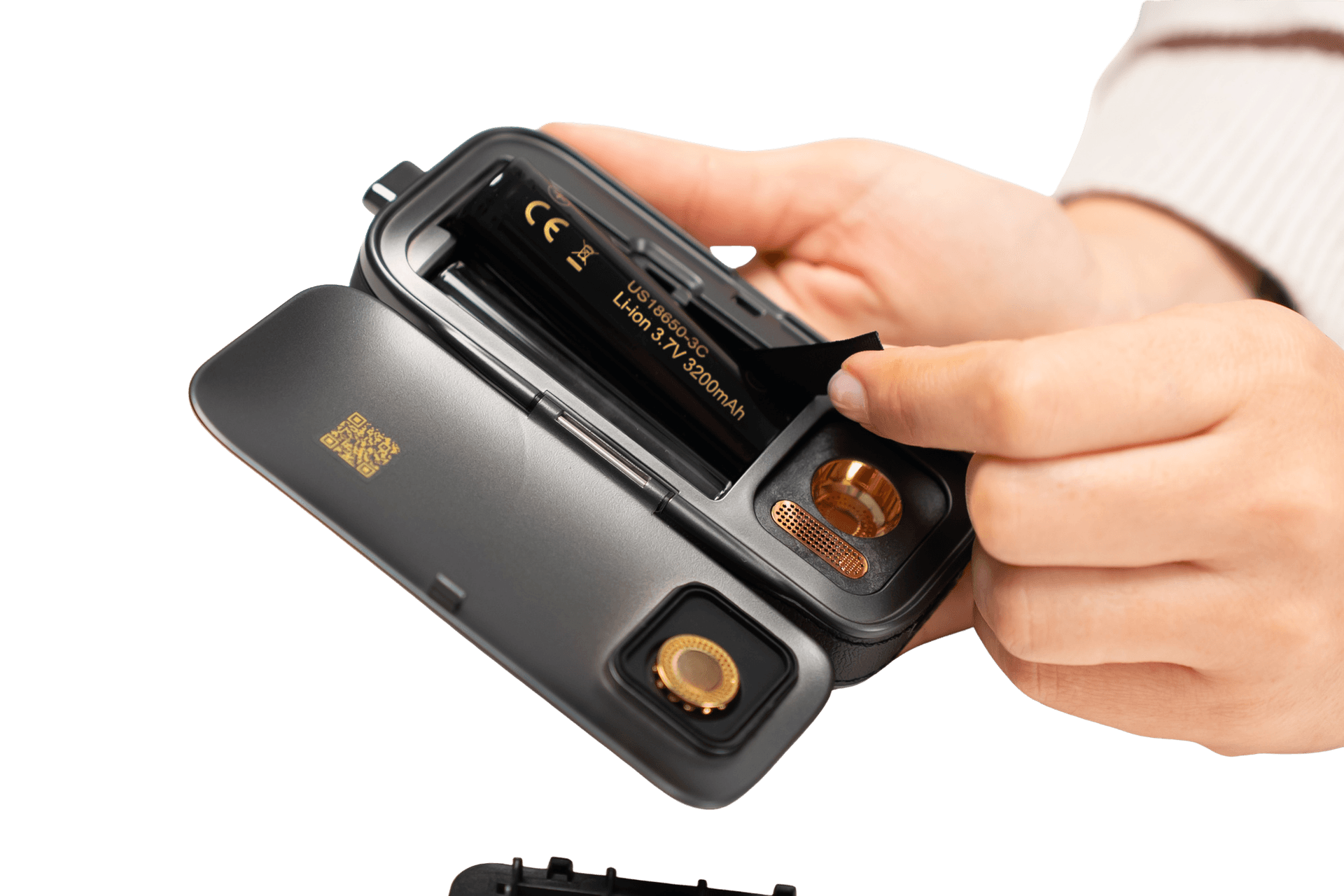 Hands opening AirVape Legacy Pro 2 battery door revealing removable 18650 cell