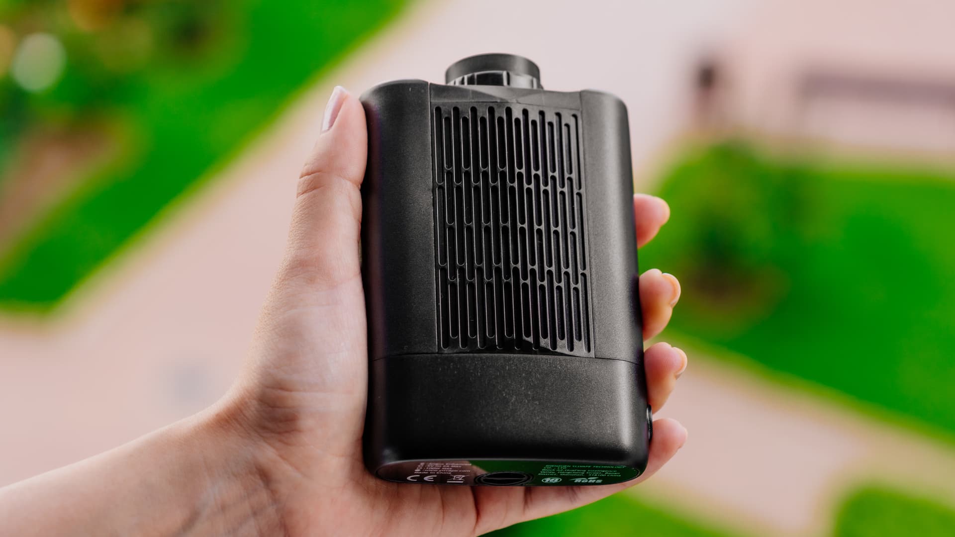 Angus Enhanced vaporizer held in hand showing rear heat fins and anodized aluminum body