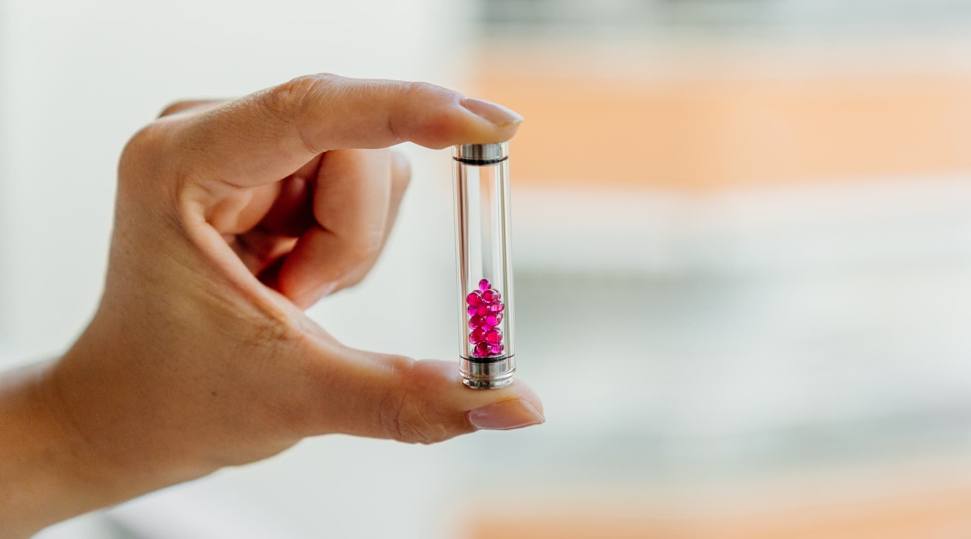 Angus Enhanced glass cooling stem held in hand showing its pink ruby terp pearls