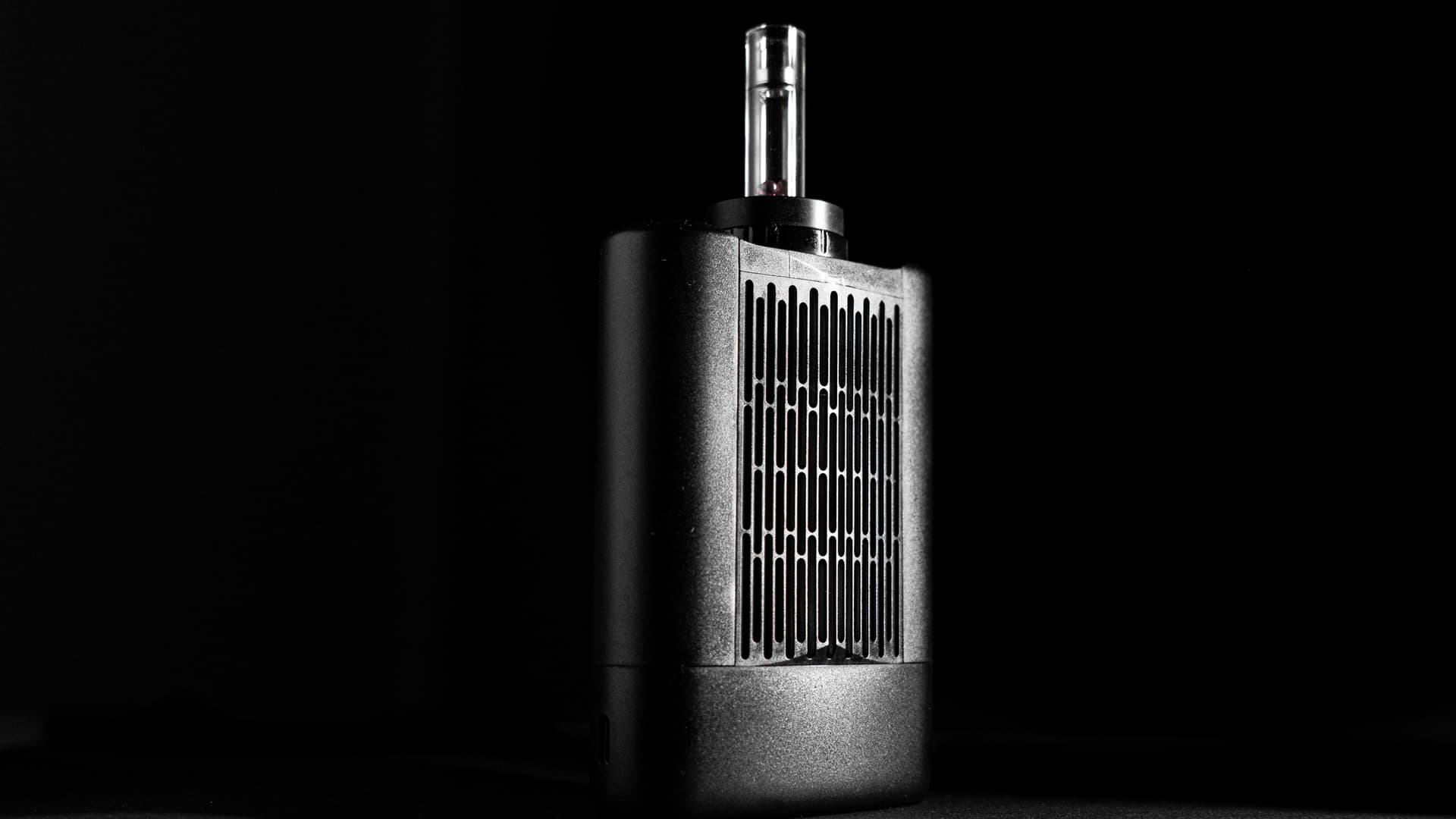 Angus Enhanced vaporizer with its halogen bulb glowing warm orange through the chamber