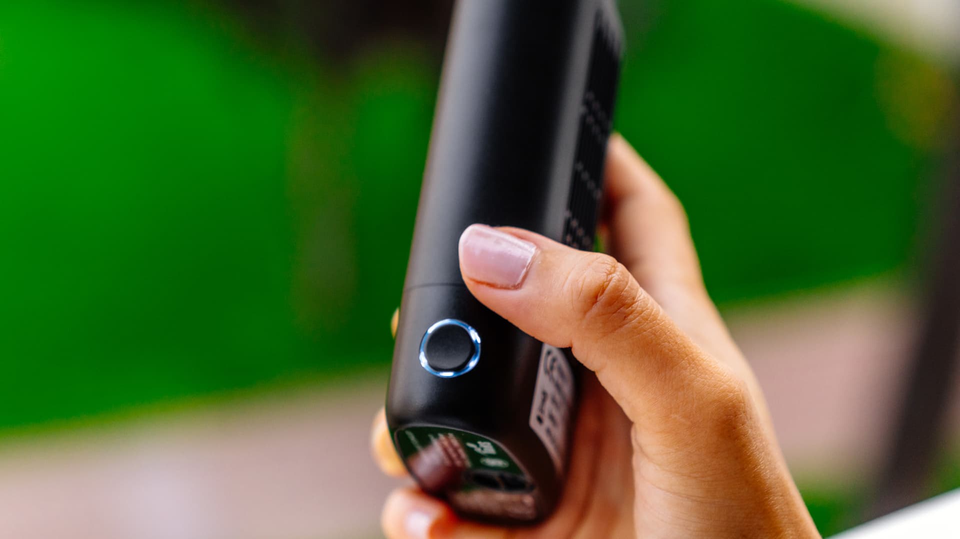 Angus Enhanced power button with blue LED ring illuminated held in hand outdoors