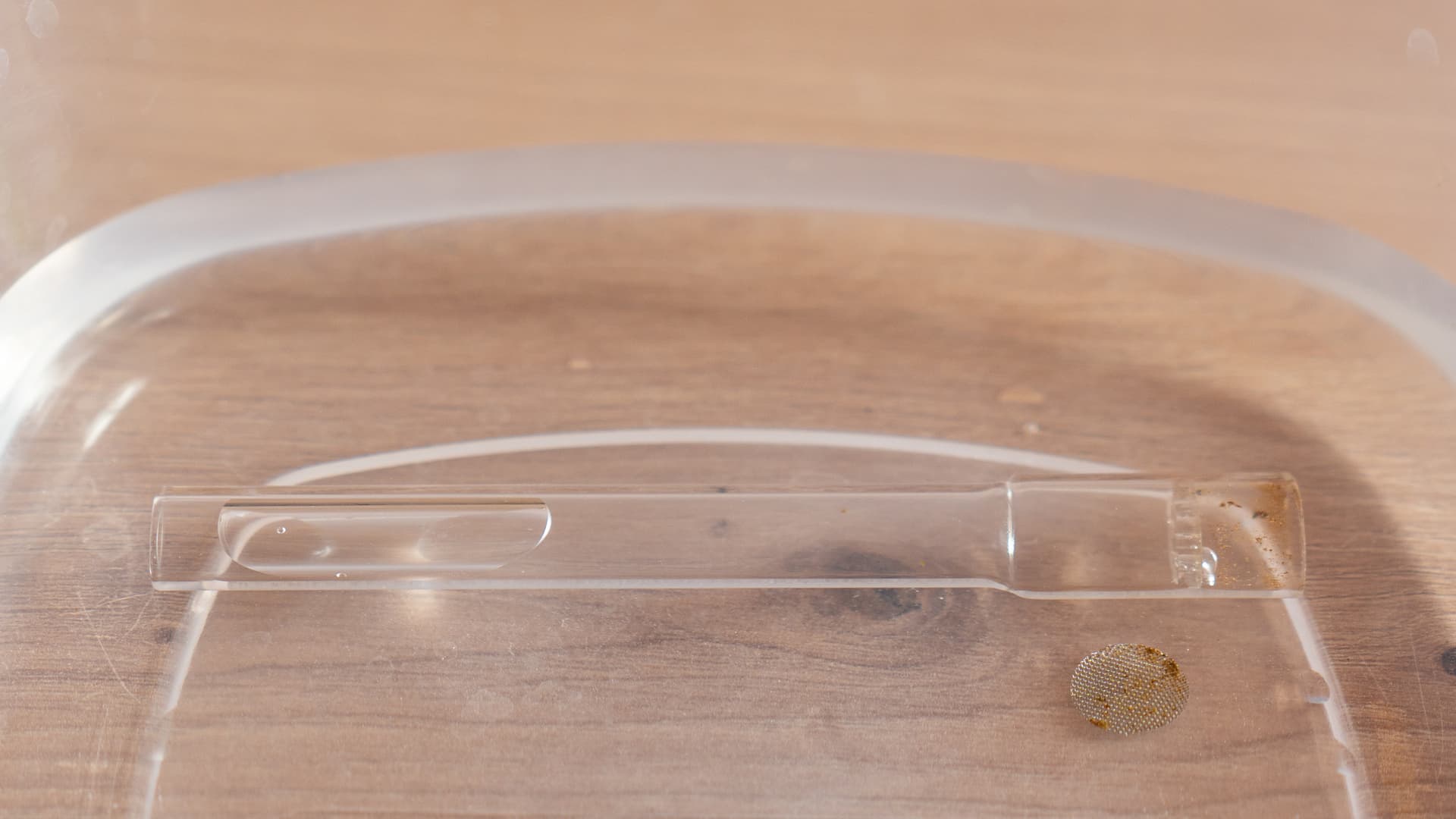 Glass stem and screen soaking in a clear dish
