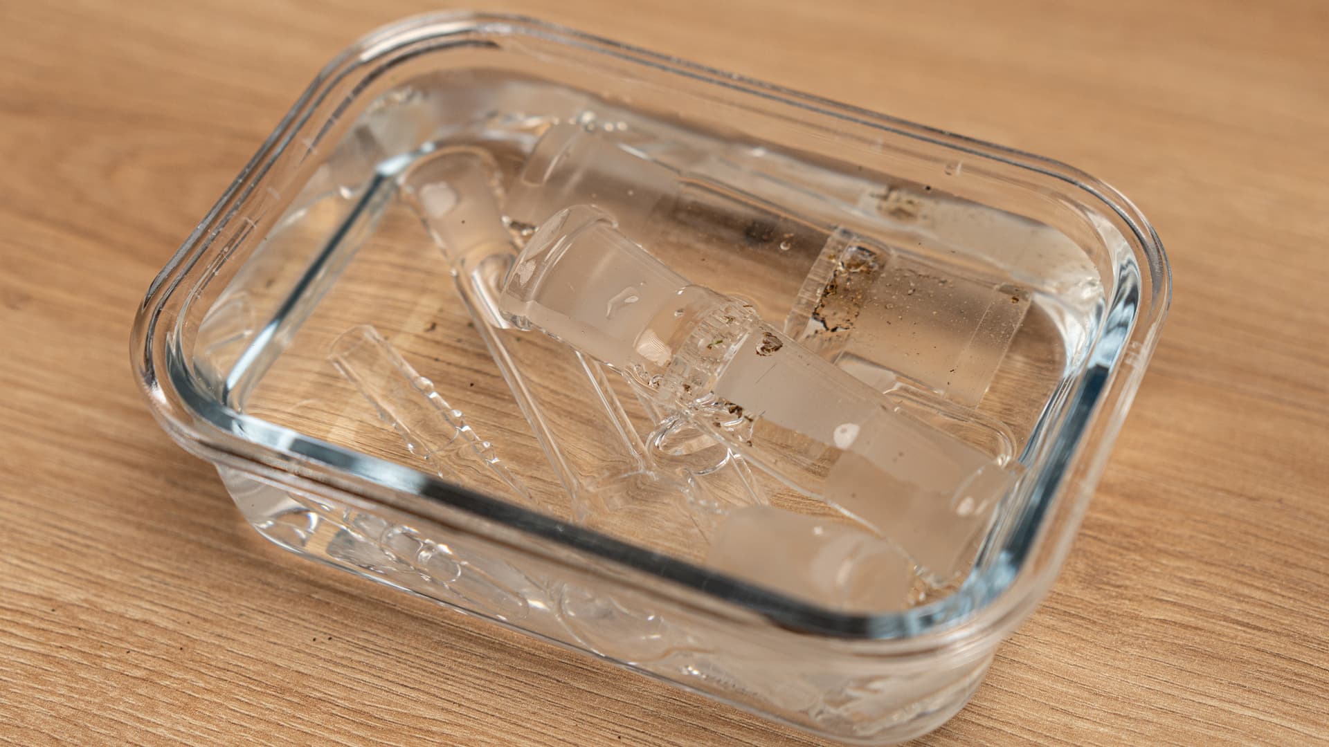 XQ2 glass parts soaking in a glass dish