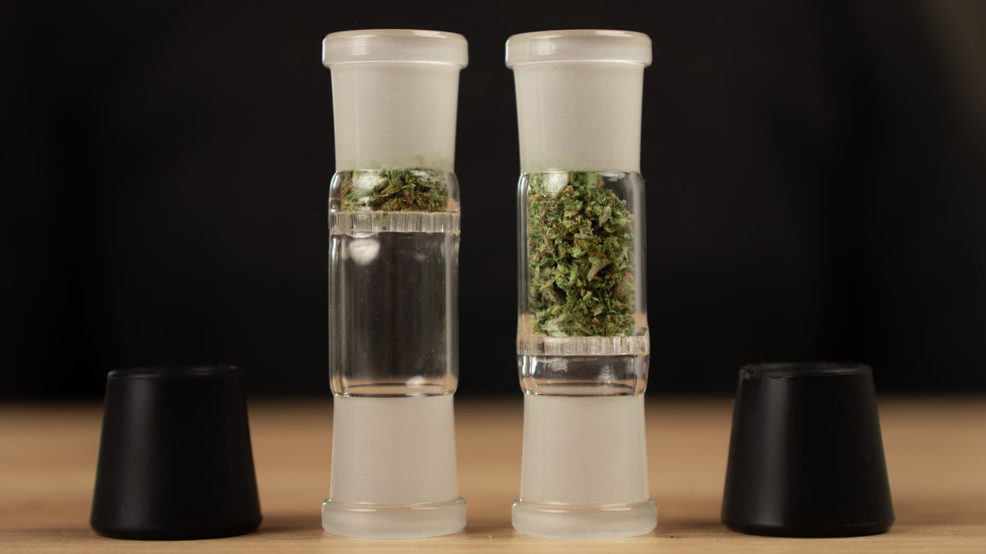 Two Arizer XQ2 glass connoisseur bowls loaded with different amounts of ground cannabis for comparison