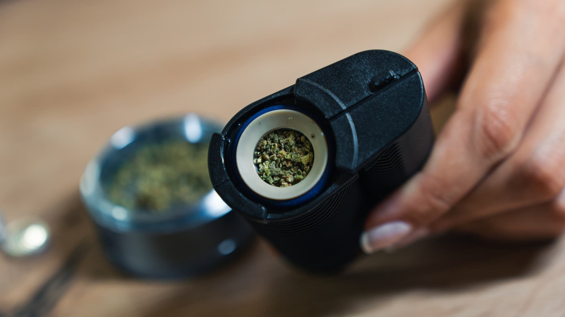 Top-down close-up of ground cannabis loaded inside a ceramic oven chamber