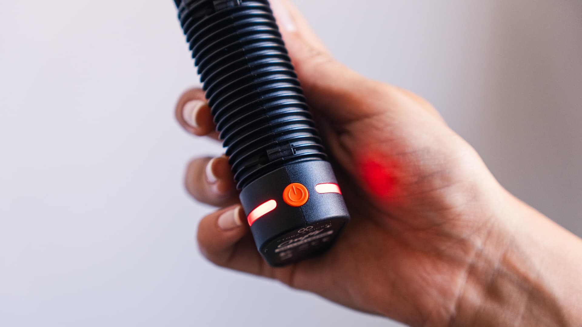 Crafty+ in hand with its red heat-up LED lit
