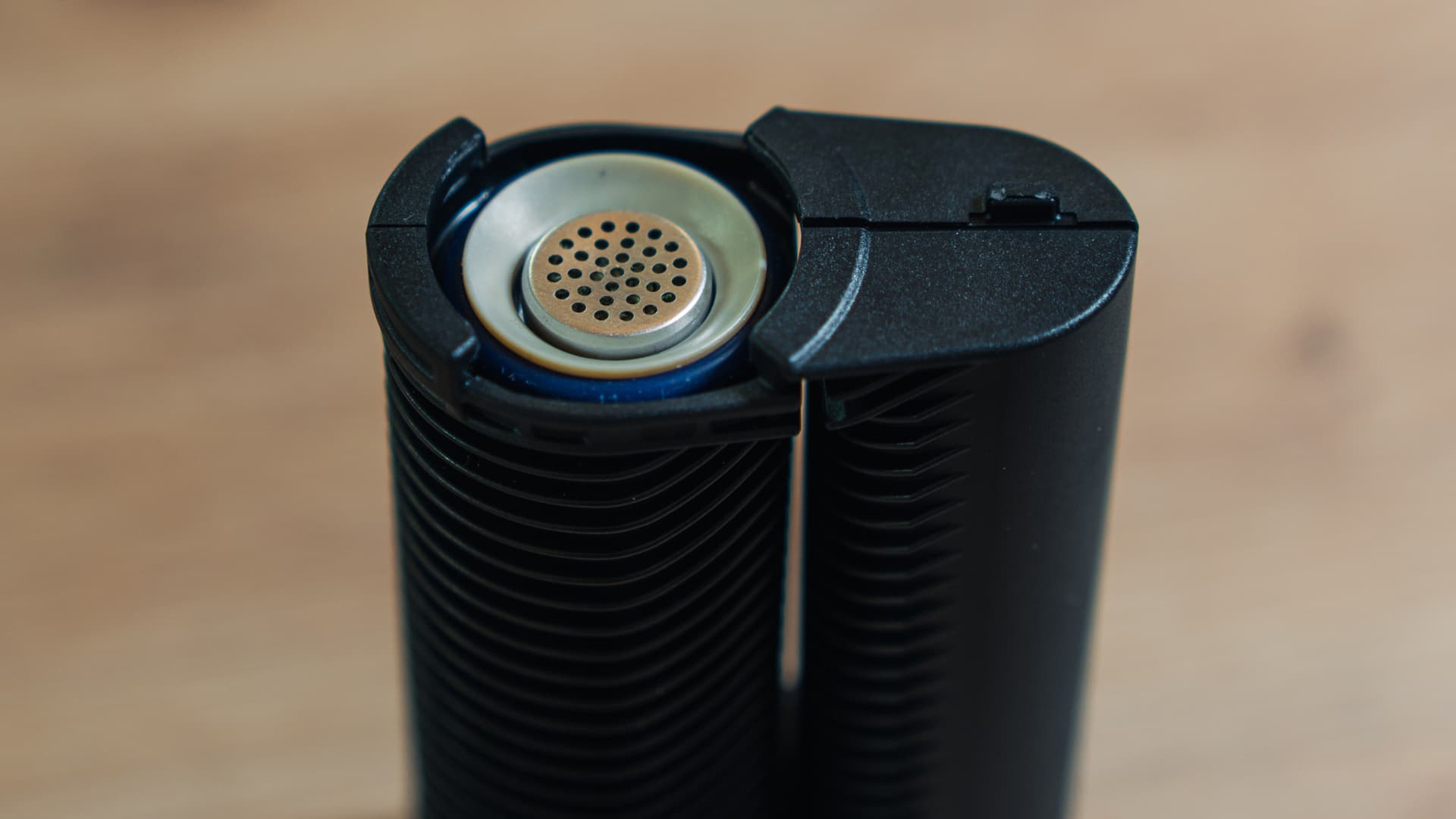 A Storz & Bickel dosing capsule seated inside an open hybrid vaporizer oven, ready for a session