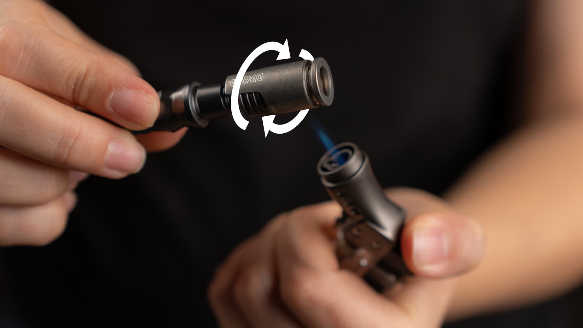 Hands heating a DynaVap HyperDyn cap with a single-flame butane torch while rotating the device, with circular rotation arrow graphic overlay