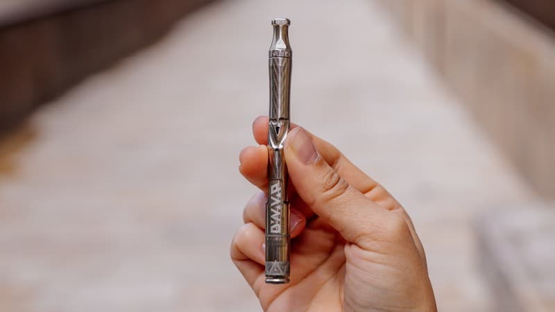 A DynaVap UniDyn with the BallR Cap portable ball vape held in hand