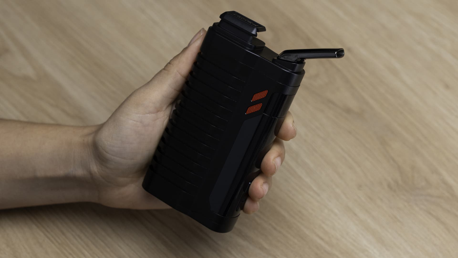 Hand holding the Fenix 2 MAX, showing the ergonomic grip and 232 g portable scale