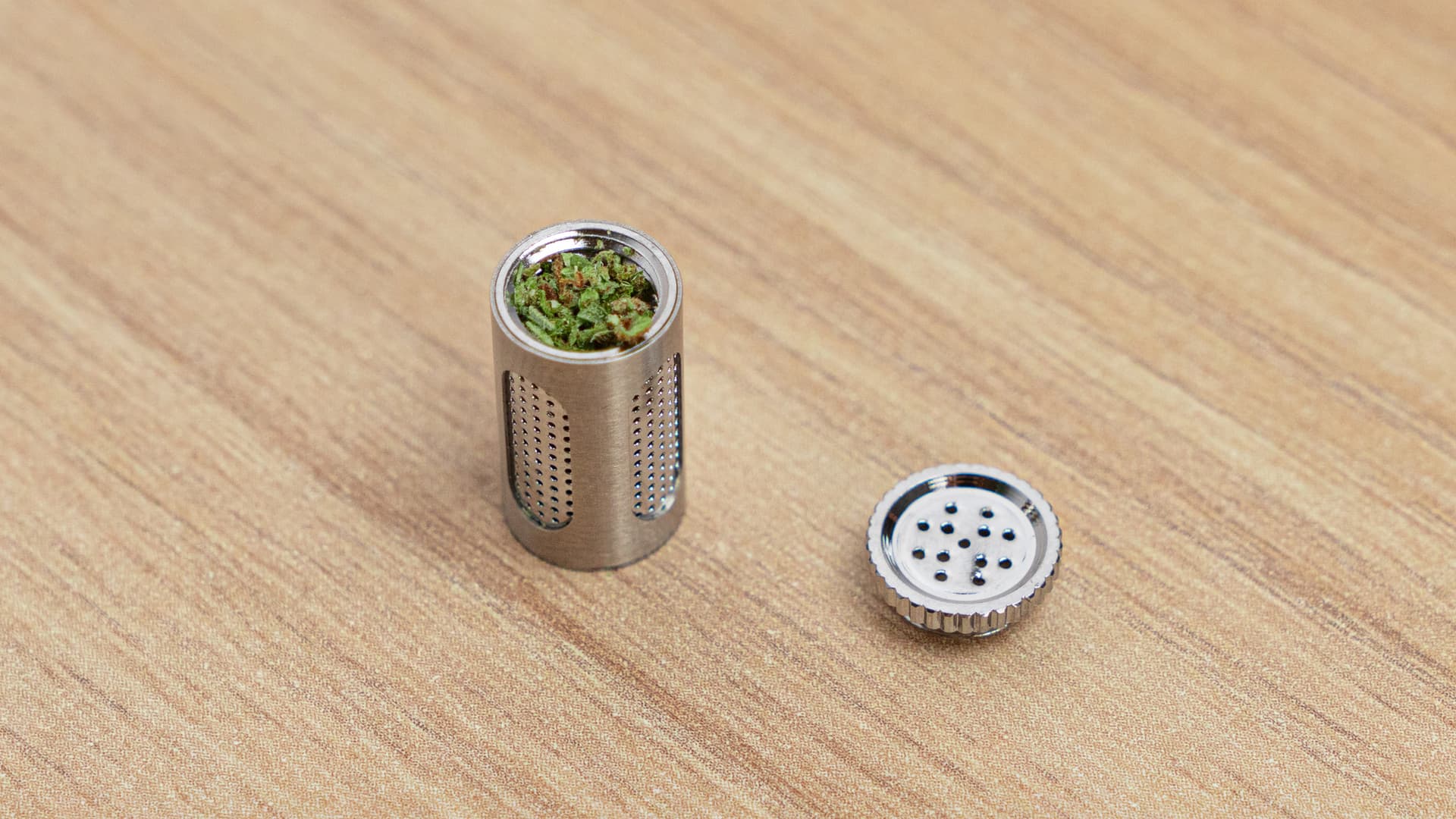 Flowermate Aura stainless steel dosing capsule loaded with herb and lid