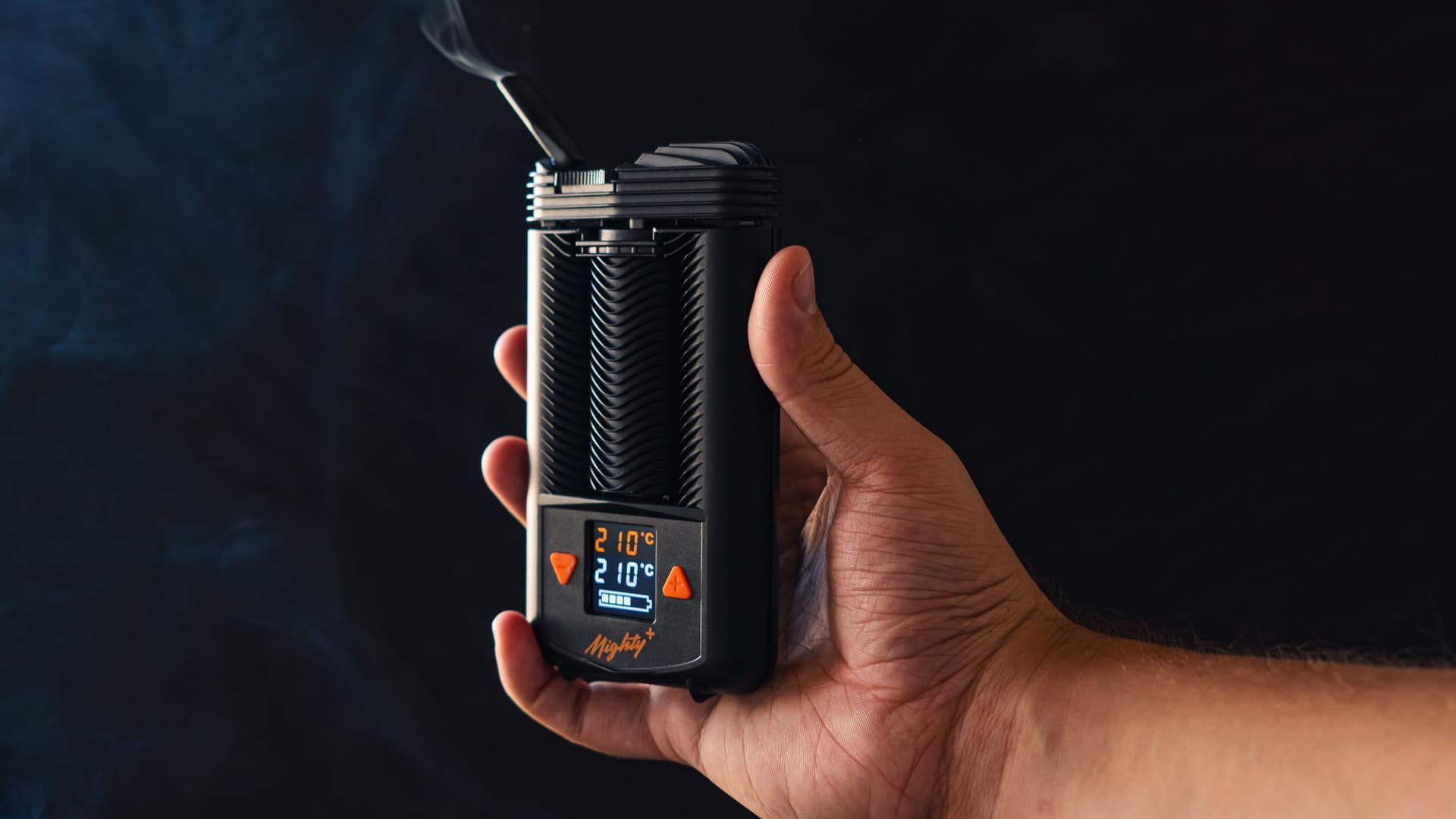 Clean cannabis vapor rising from a portable vaporizer mouthpiece against a dark background