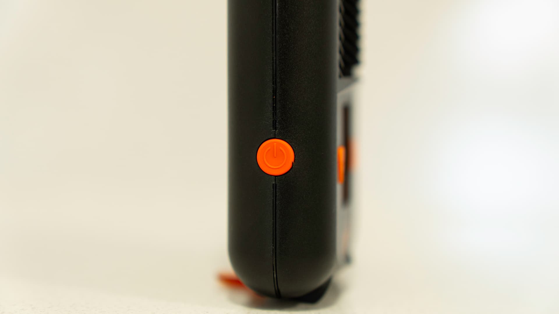 Orange power button on the side of the Mighty+