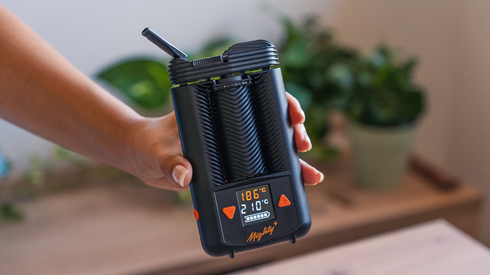 Reassembled Mighty+ held in hand, display lit