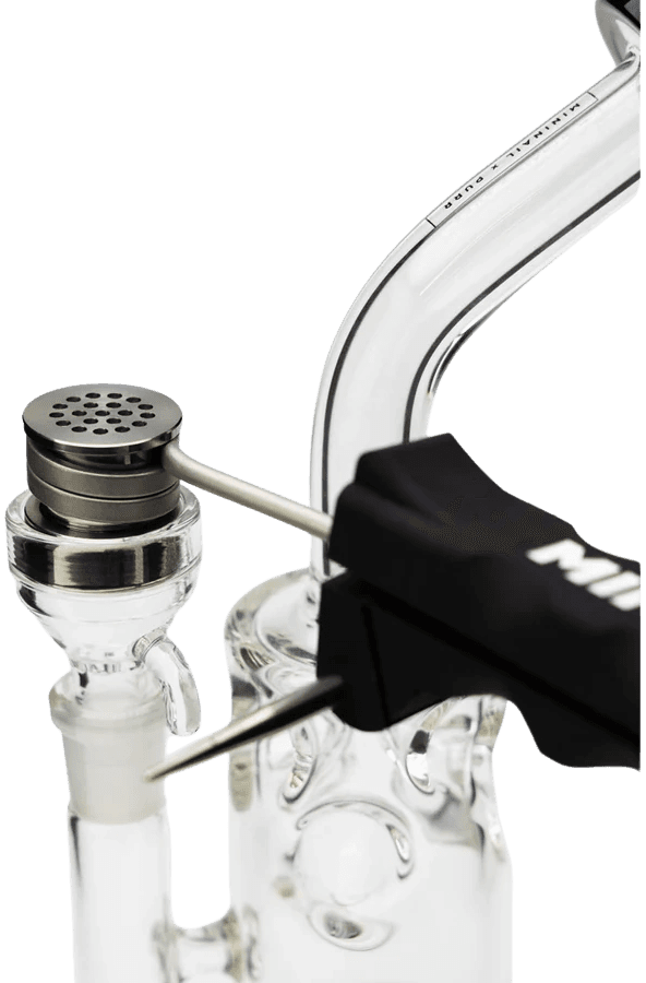 MiniNail Flower Wand seated on a glass bubbler rig with the titanium bowl in place and the stir tool within reach