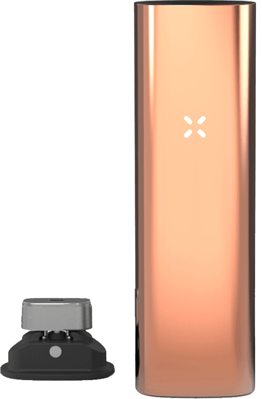 Rose gold PAX 3 standing next to magnetic charging dock showing charging connection