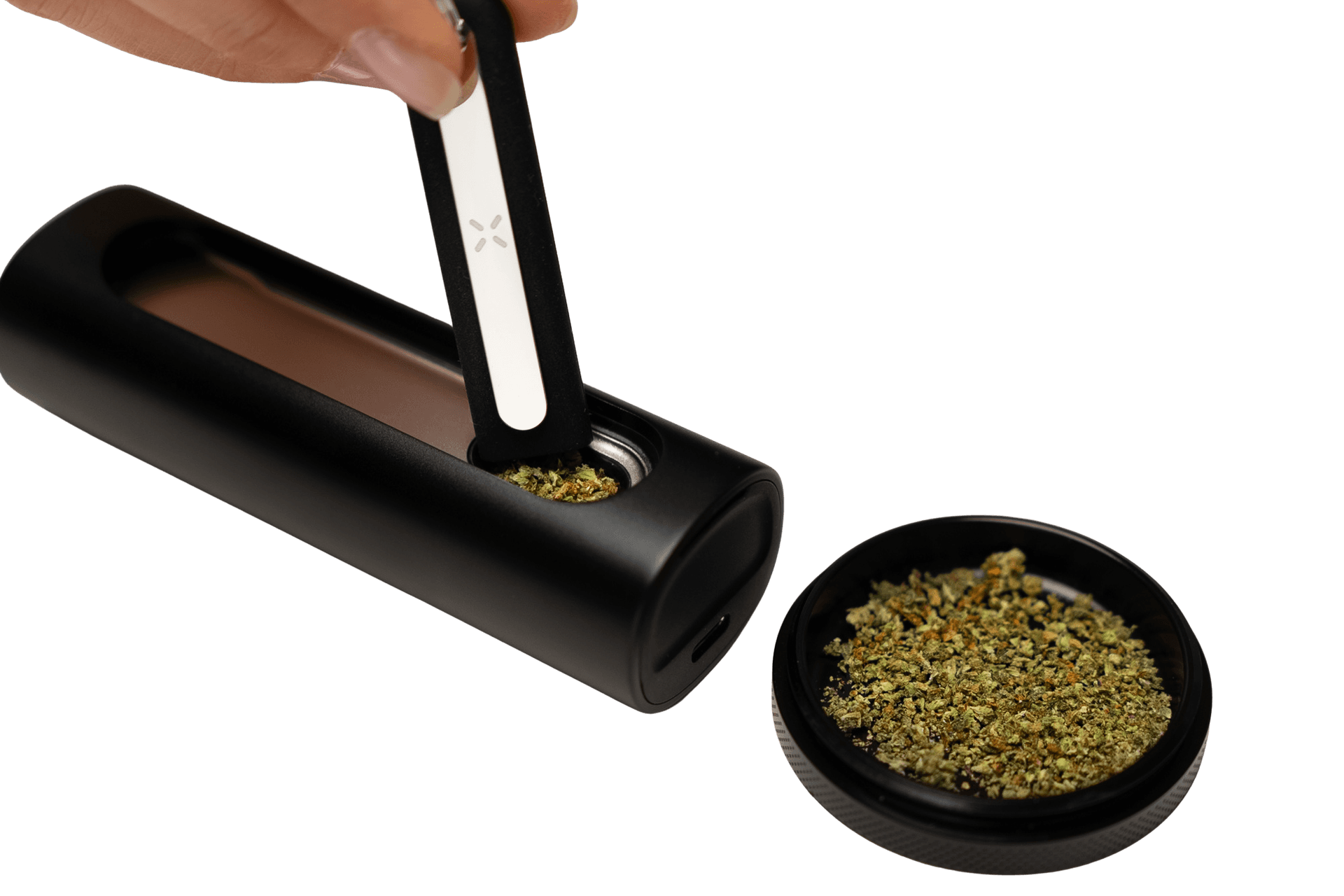 Loading the PAX Flow side-mounted oven with ground herb using the scooping tool