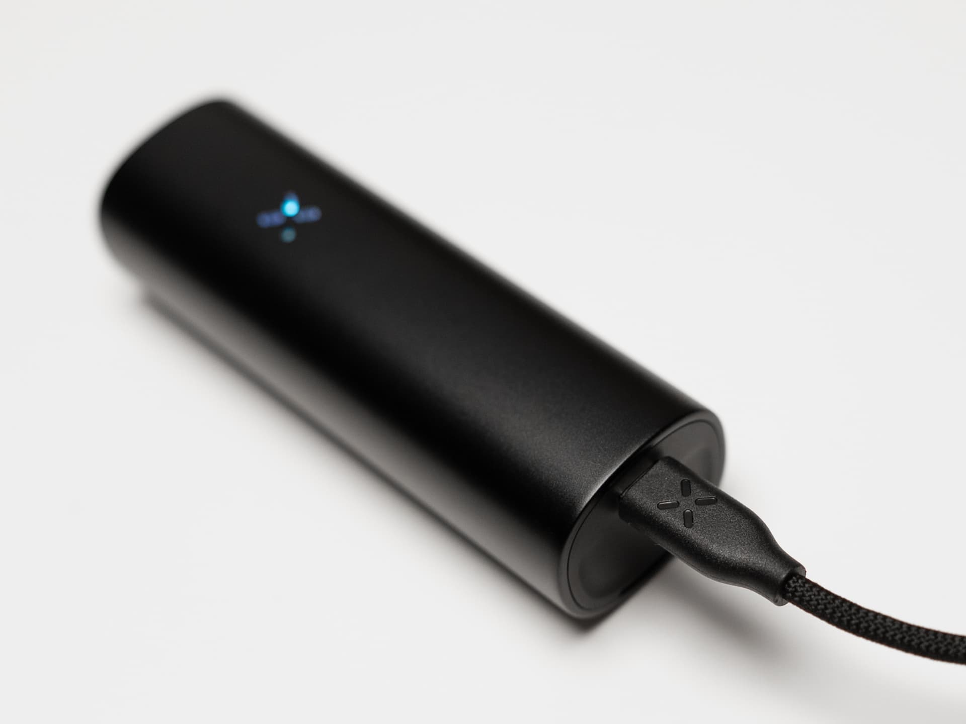 PAX Flow charging via braided USB-C cable in the base port with LED indicator lit