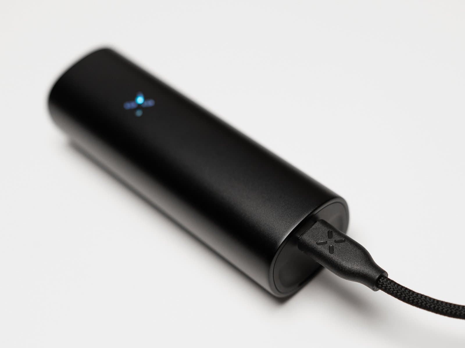 PAX Flow charging over USB-C with its petals lit blue