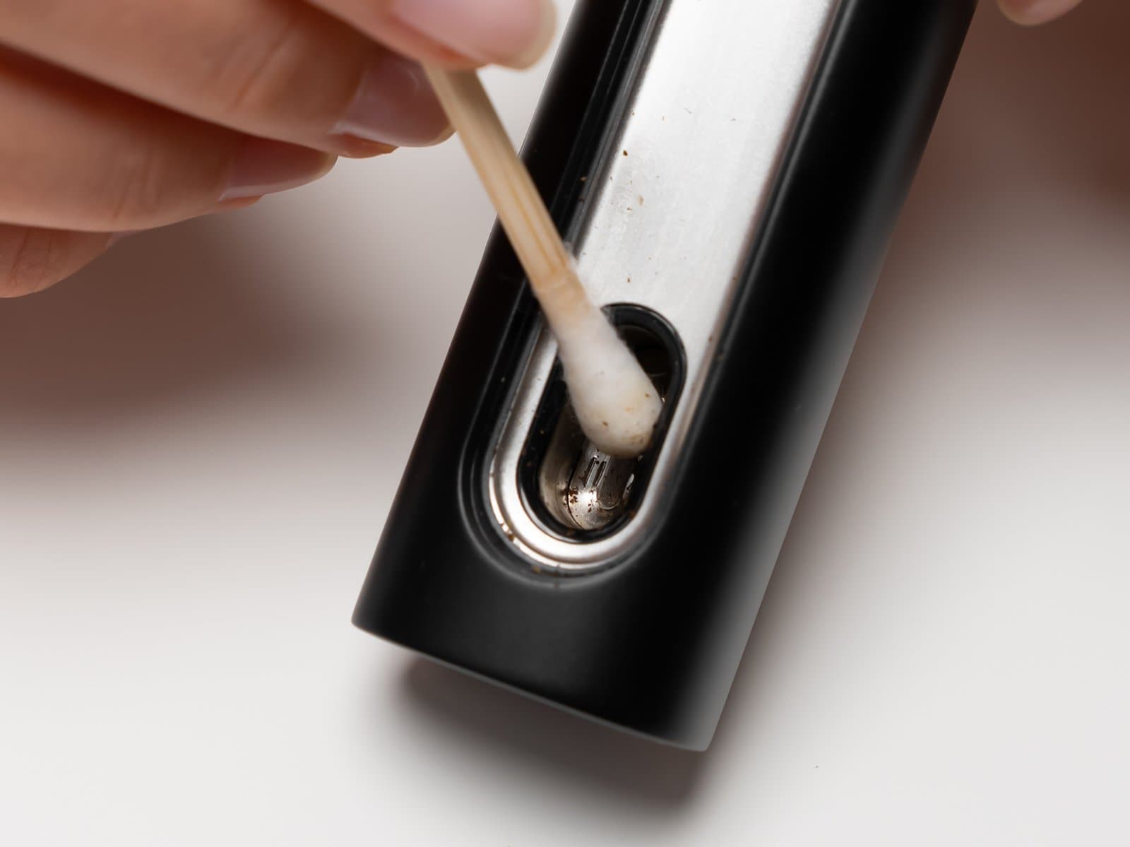 Cotton swab cleaning the PAX Flow oven chamber