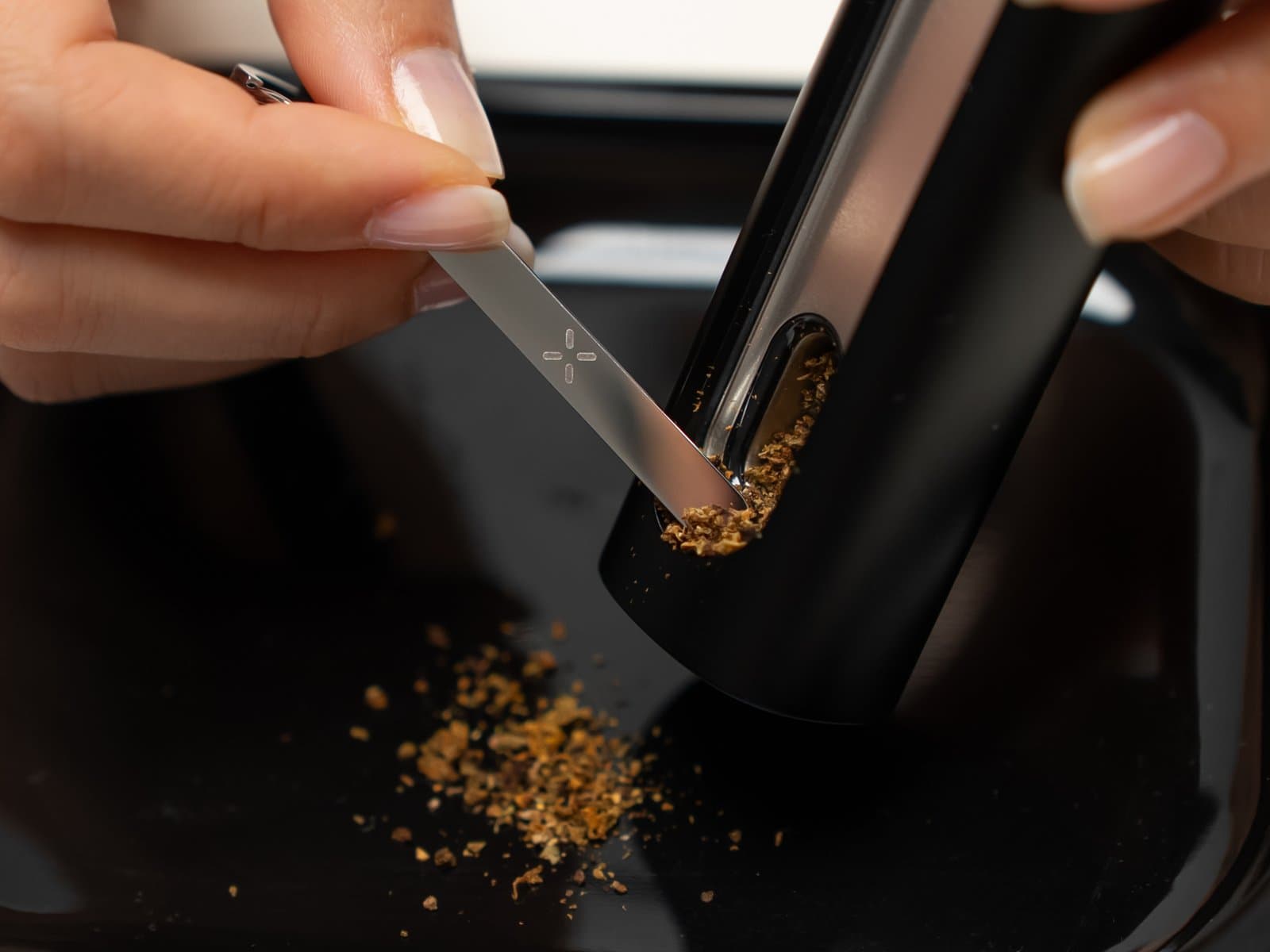 Scraping spent cannabis out of the PAX Flow oven with the multi-tool