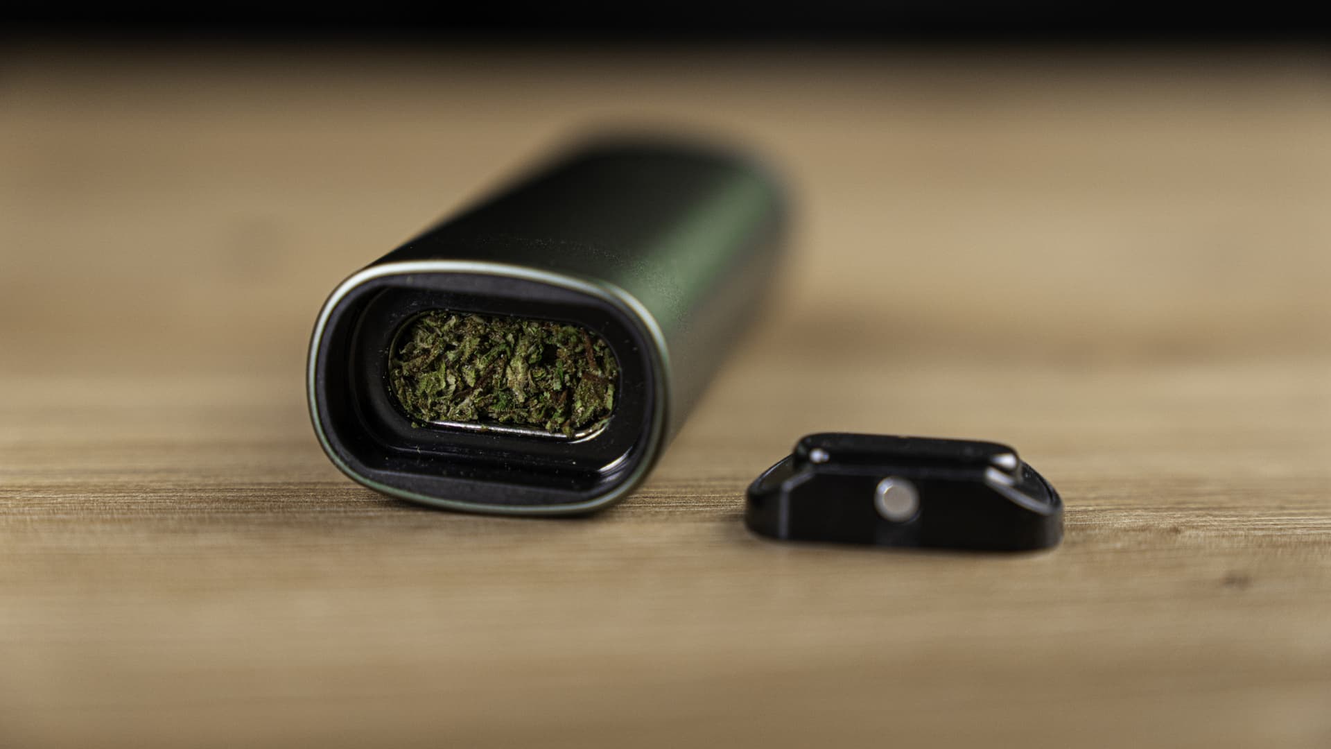 A PAX Plus conduction oven loaded with ground cannabis pressed against the heated steel chamber