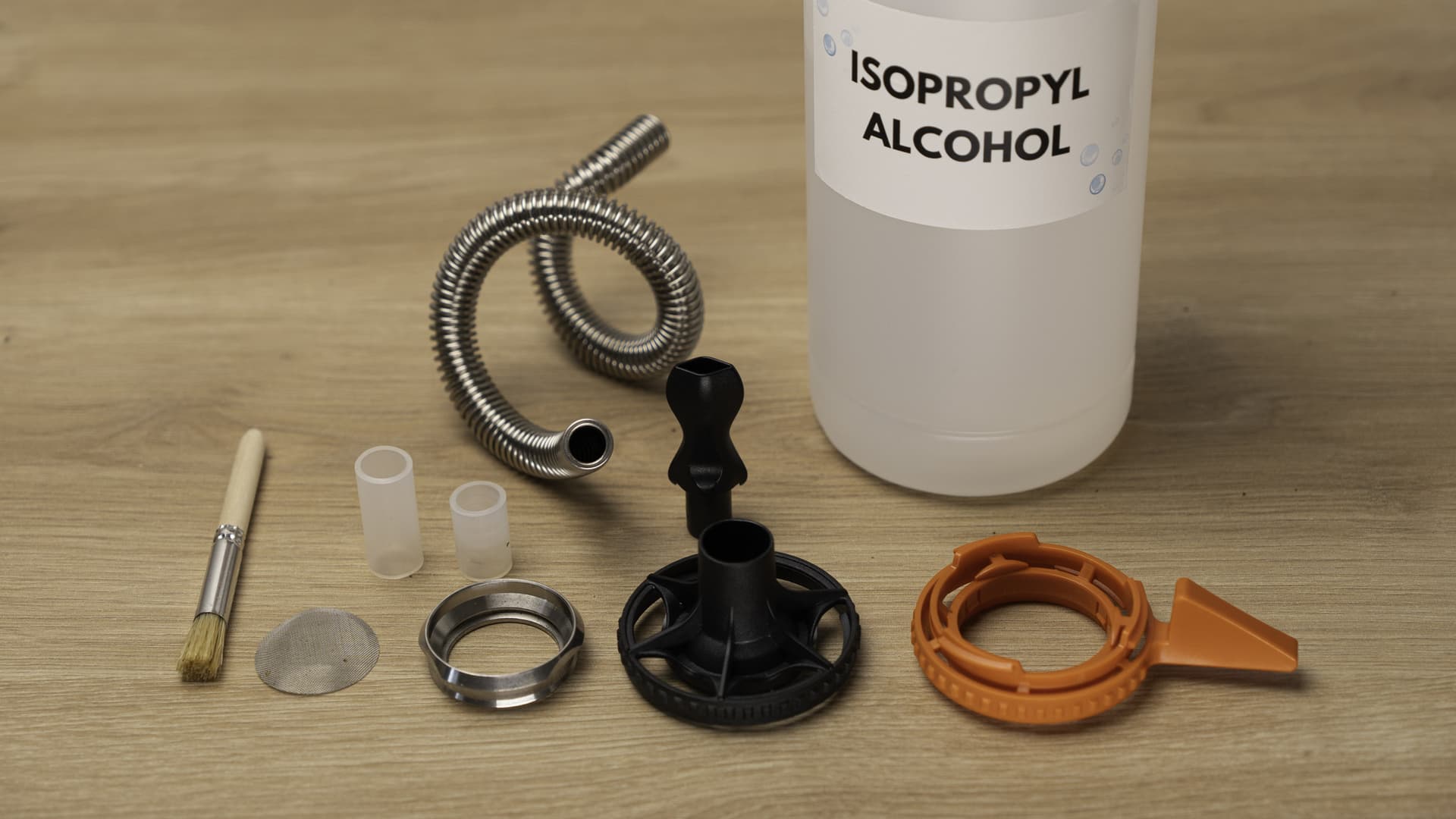 Plenty parts laid out beside a bottle of isopropyl alcohol