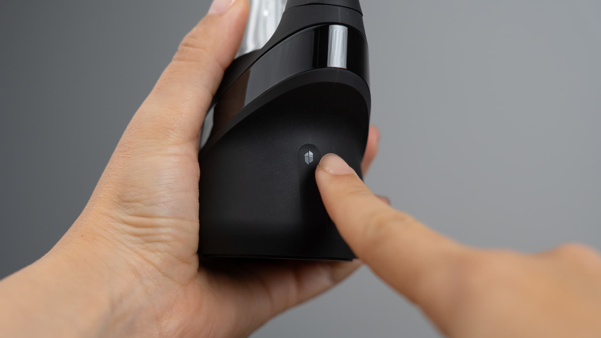 Finger pressing the Puffco New Peak button