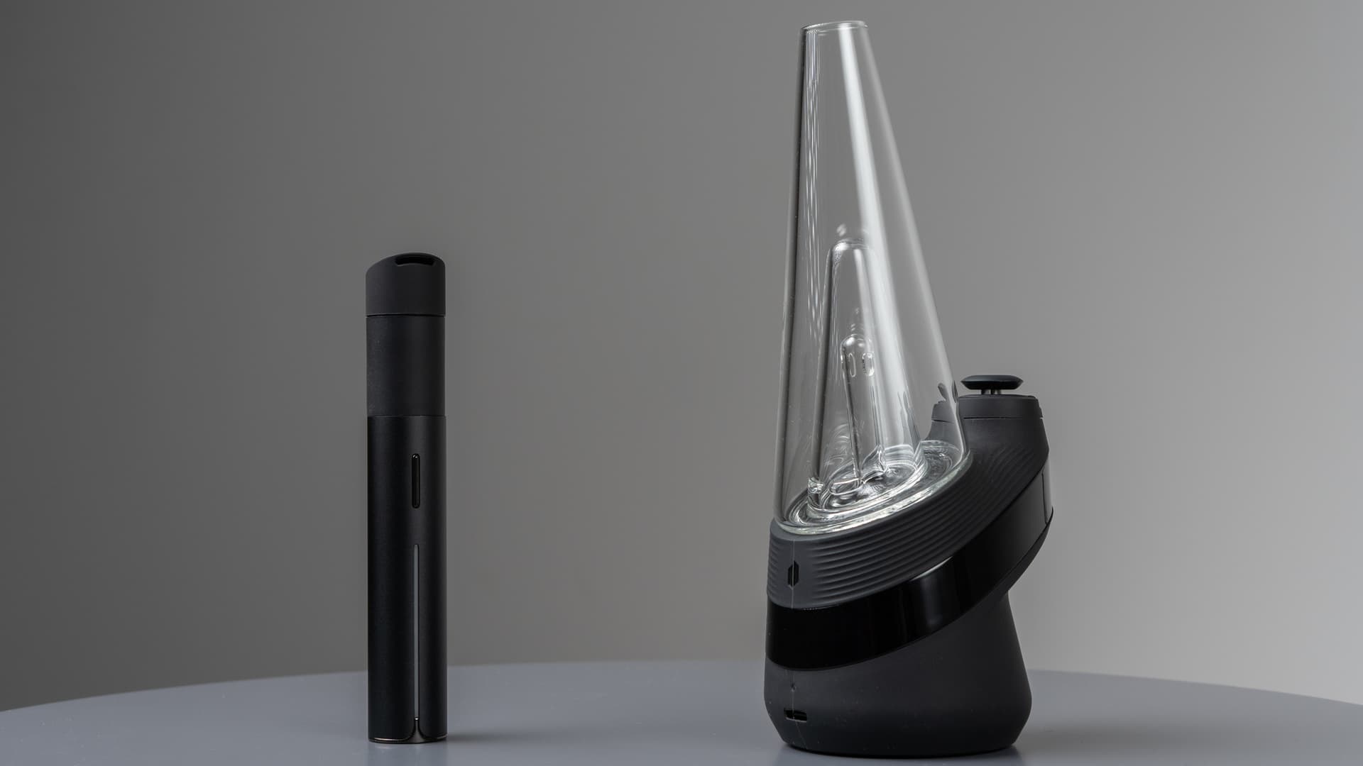 Puffco New Peak neben einem Pen-Vaporizer, der den Größenunterschied zwischen eRigs und Pen-Vaporizern zeigt