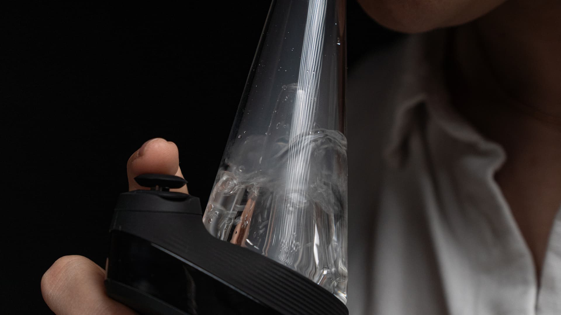 Close-up of vapor percolating through the Puffco Peak Pro glass bubbler with visible bubbles in the water chamber during a draw