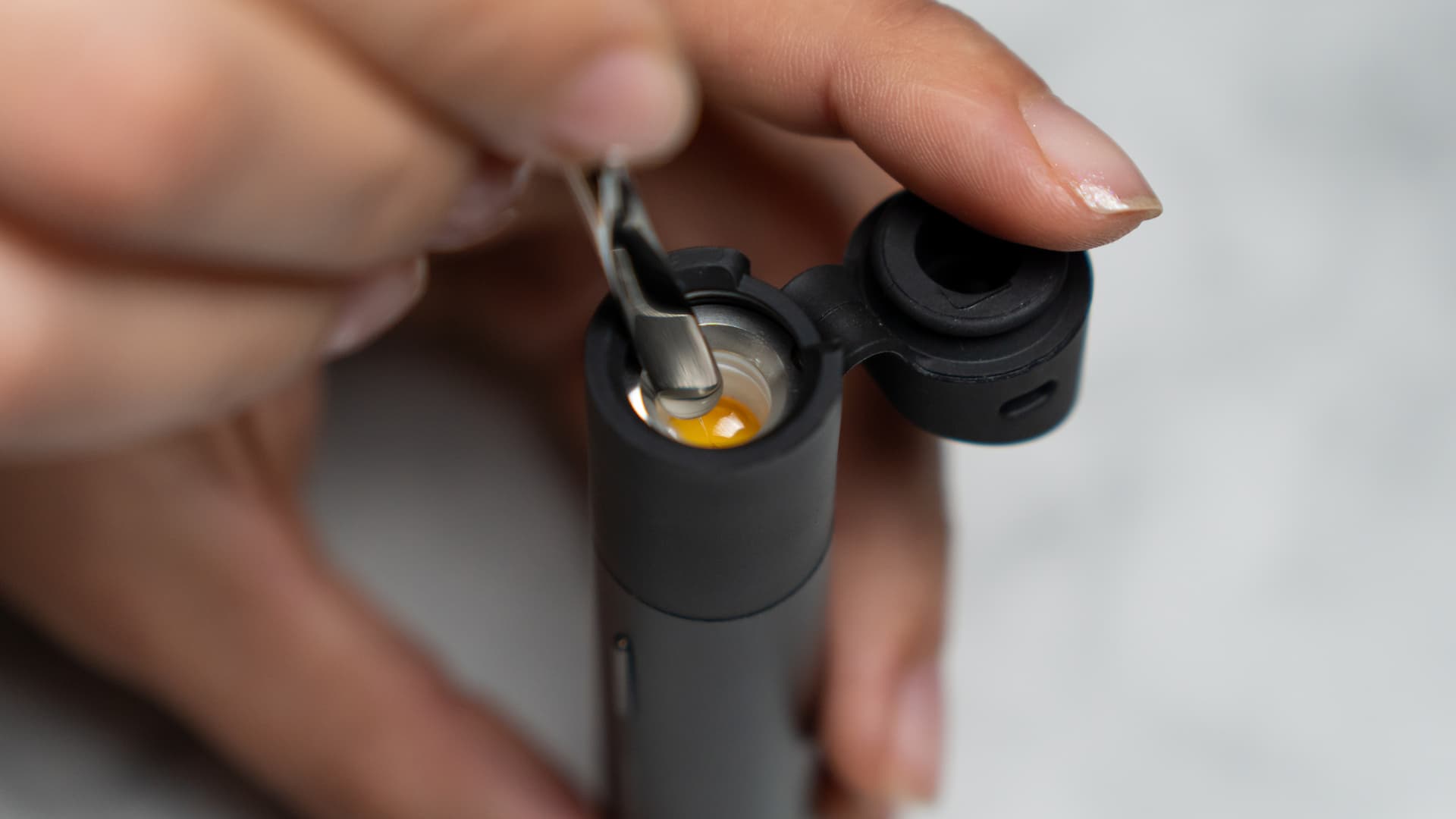 Close-up detail of the Puffco Pivot's 3D ceramic chamber being loaded with concentrate