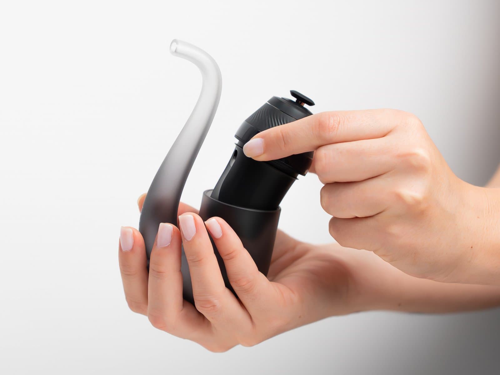 Hands inserting the Proxy base into its Sherlock glass pipe