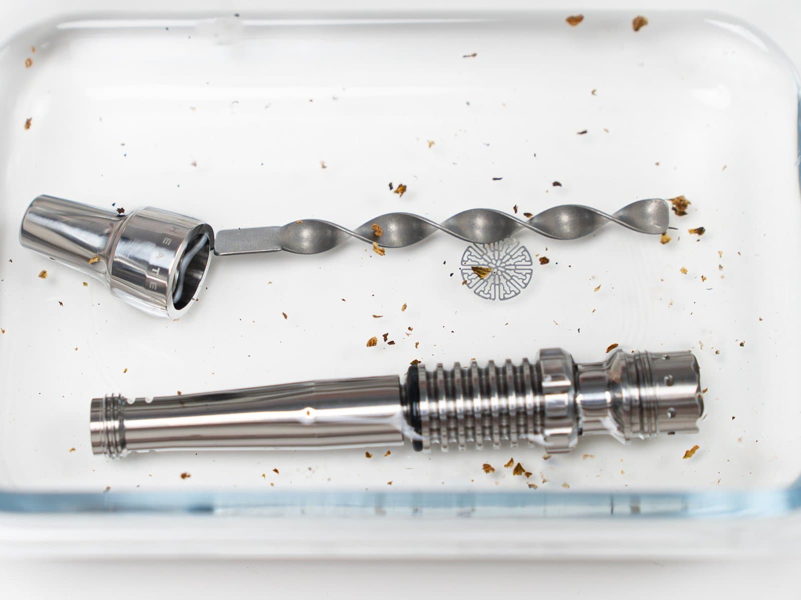 Tempest 2 stem, mouthpiece, spiral insert and a screen soaking in isopropyl alcohol