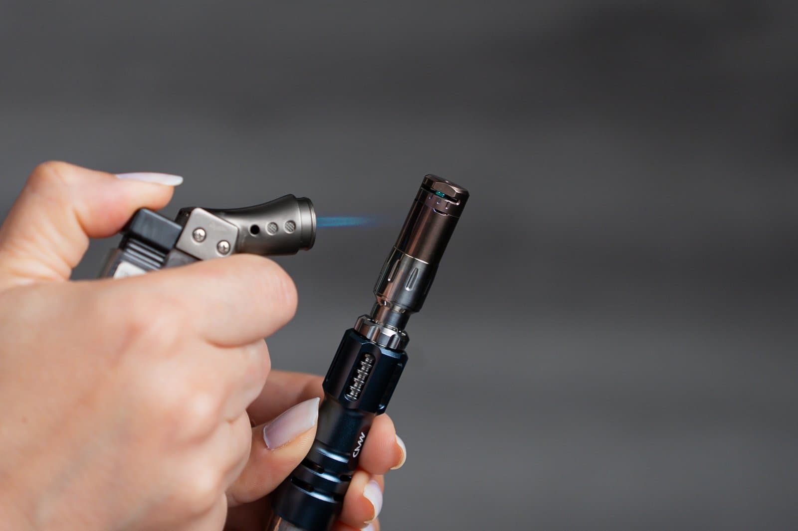 Butane torch heating the Tempest 2 cap in hand