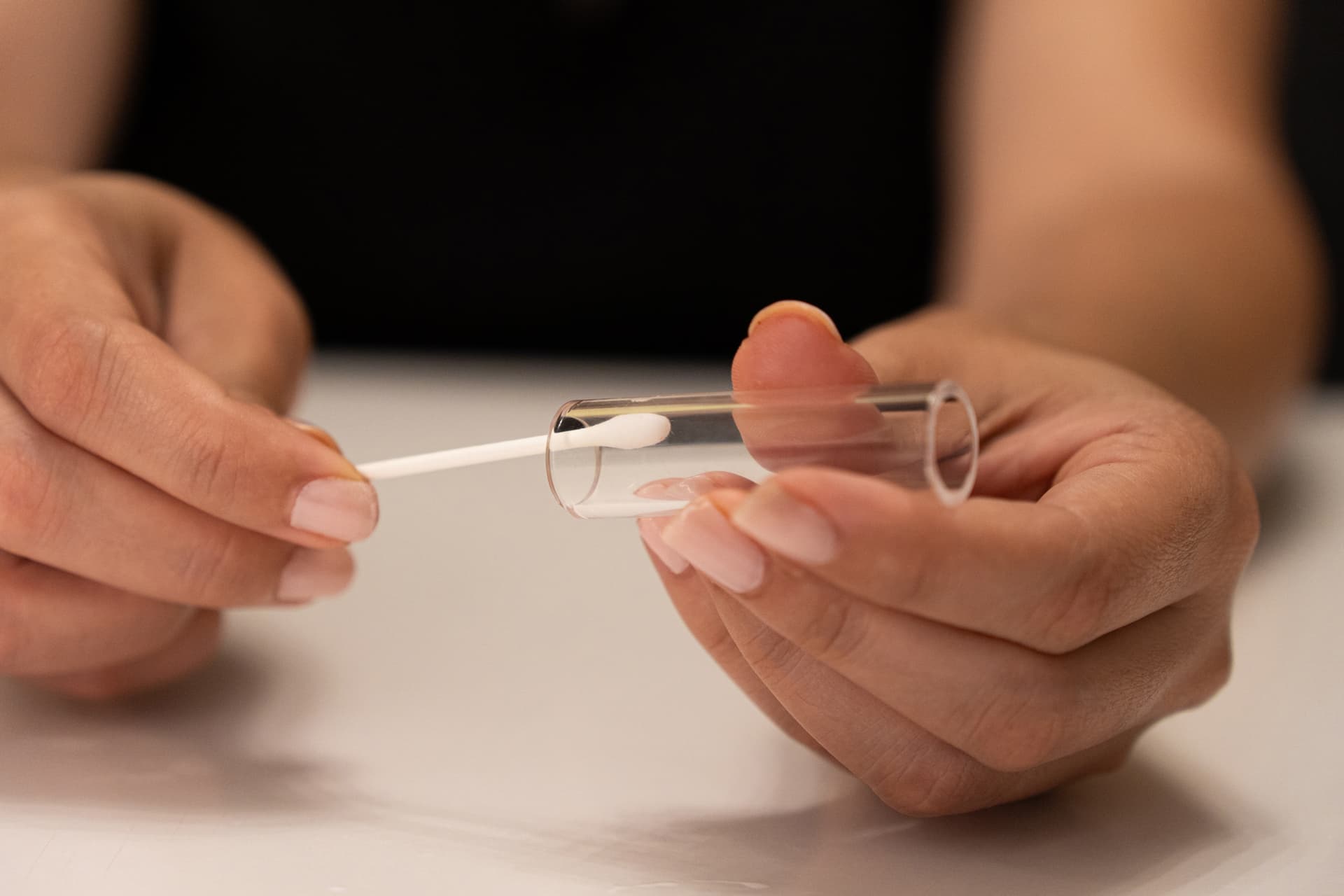 Detached glass tube being wiped with a swab