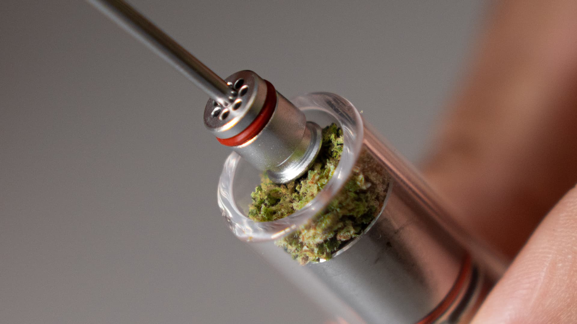 Tinymight 2 glass cooling stem being loosely loaded with coarser ground cannabis