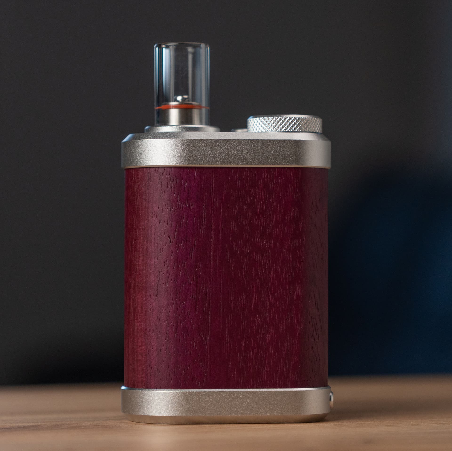 Vaporizer Tinymight 2 aus Purpleheart-Holz mit Glas-Kühleinheit auf einer Holzfläche