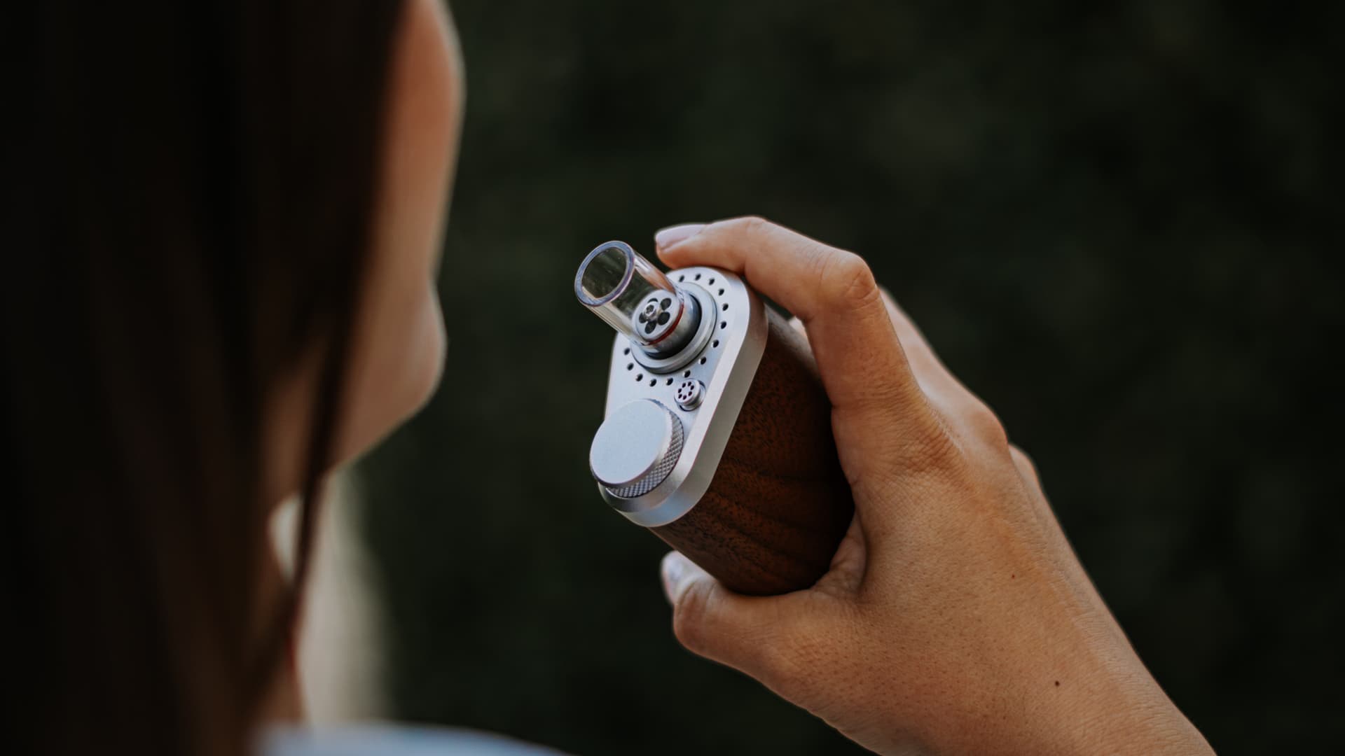 Person holding a walnut Tinymight 2 near the mouth