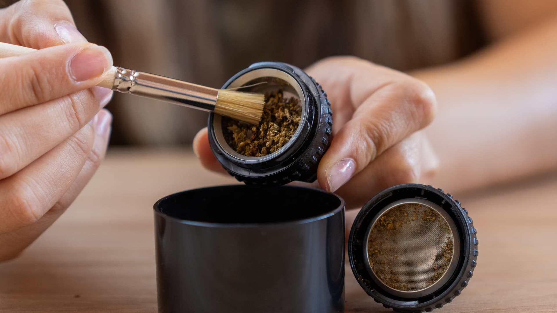 Brushing cannabis residue from Volcano Classic filling chamber with included cleaning brush