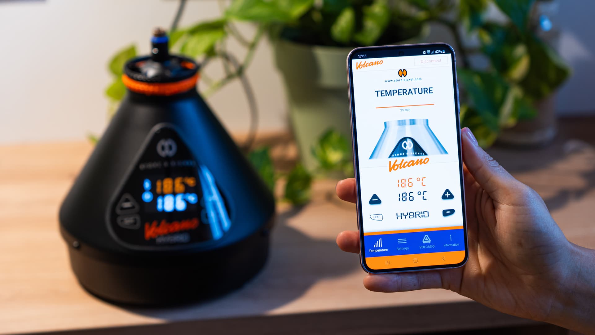 Storz & Bickel app on smartphone showing 186°C synced with Volcano Hybrid in background