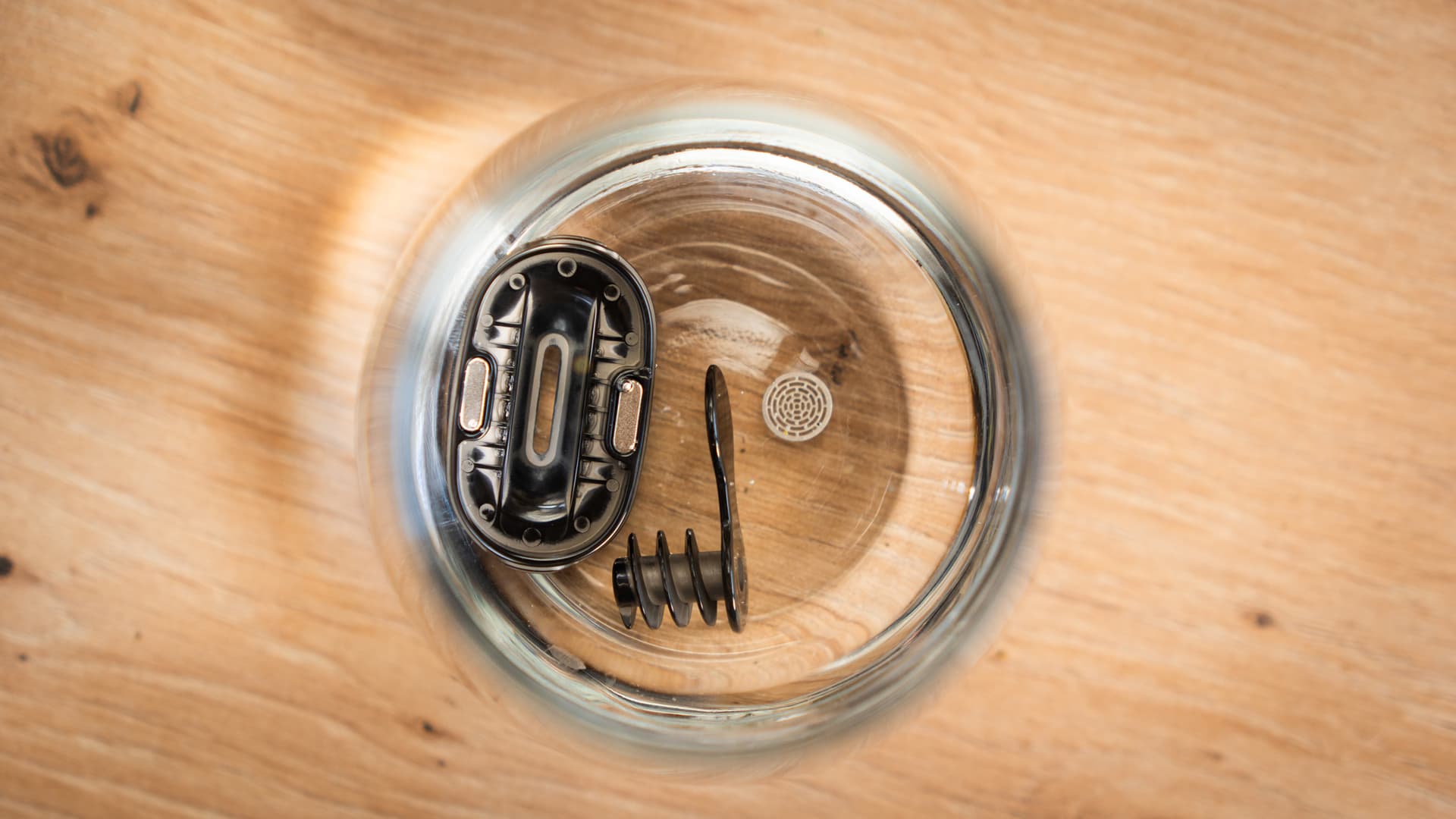 XLUX Roffu mouthpiece parts, spiral cooling insert and a screen soaking in a glass bowl