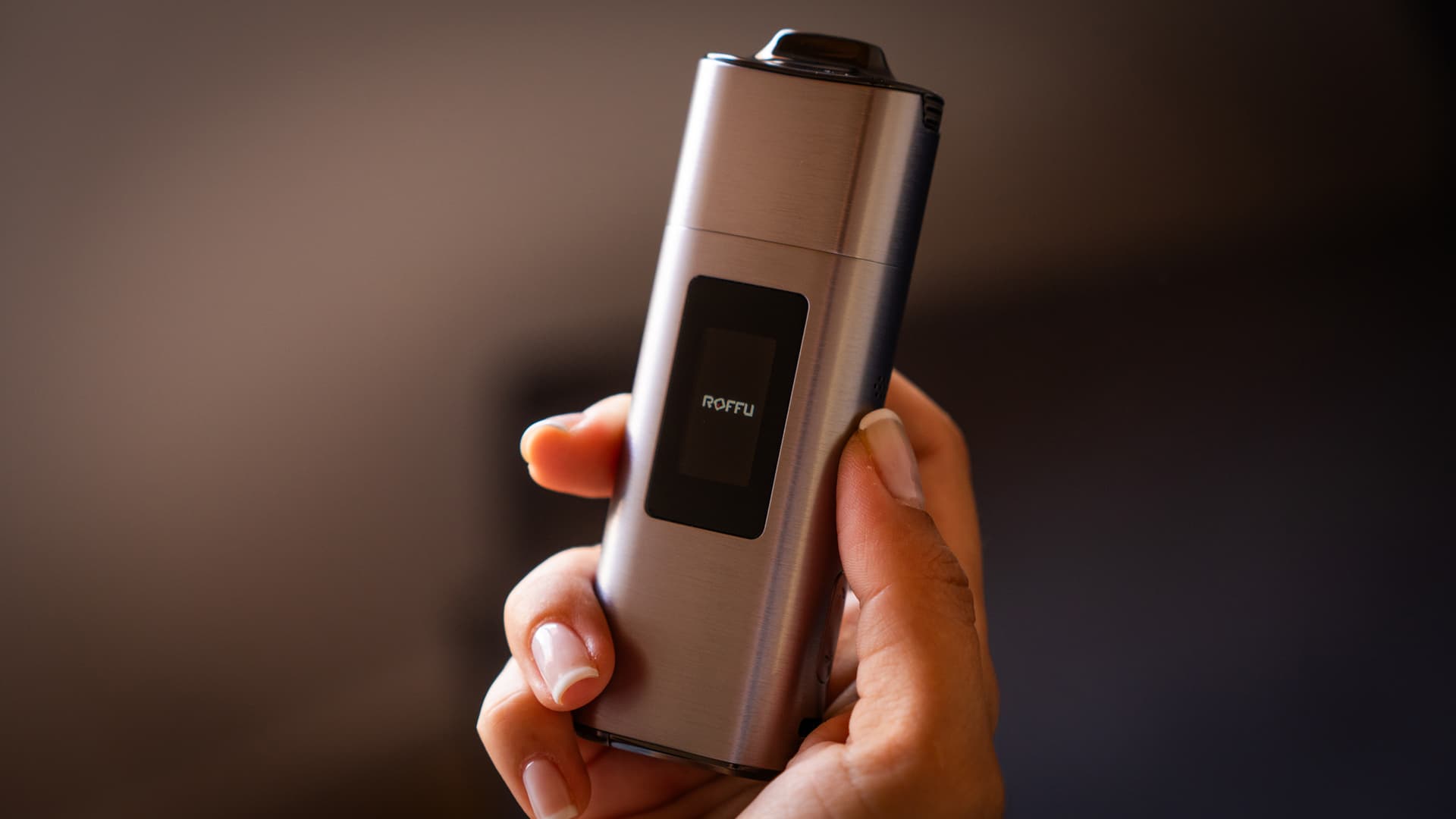 Silver XLUX Roffu in hand with the Roffu logo on its start-up screen