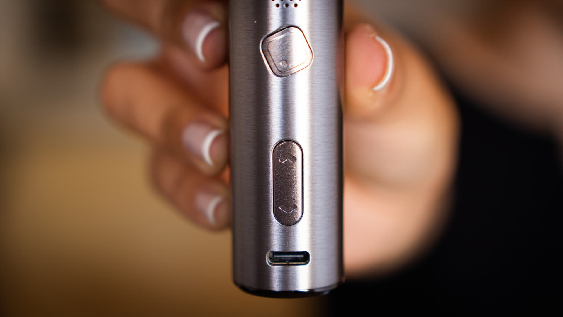 Close-up of the XLUX Roffu's diamond power button, up and down rocker and USB-C port