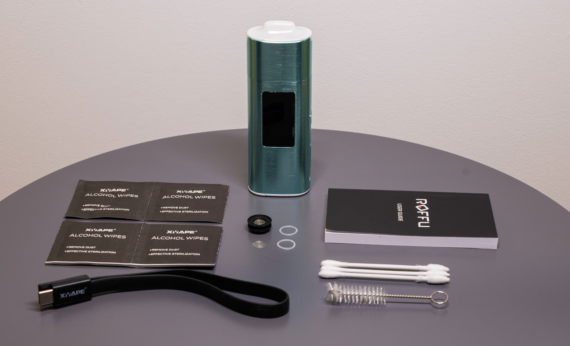 Roffu standing beside its cable and cleaning accessories
