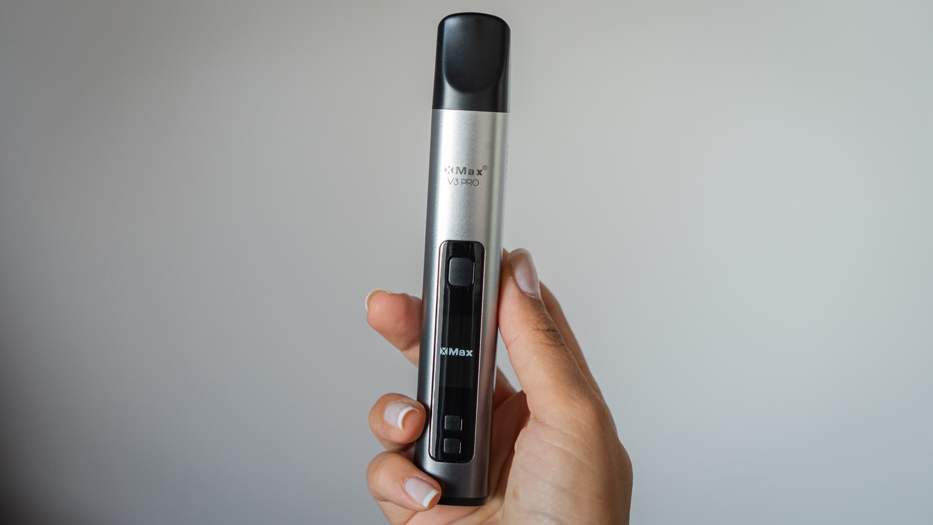 Silver XMax V3 Pro held upright in a hand