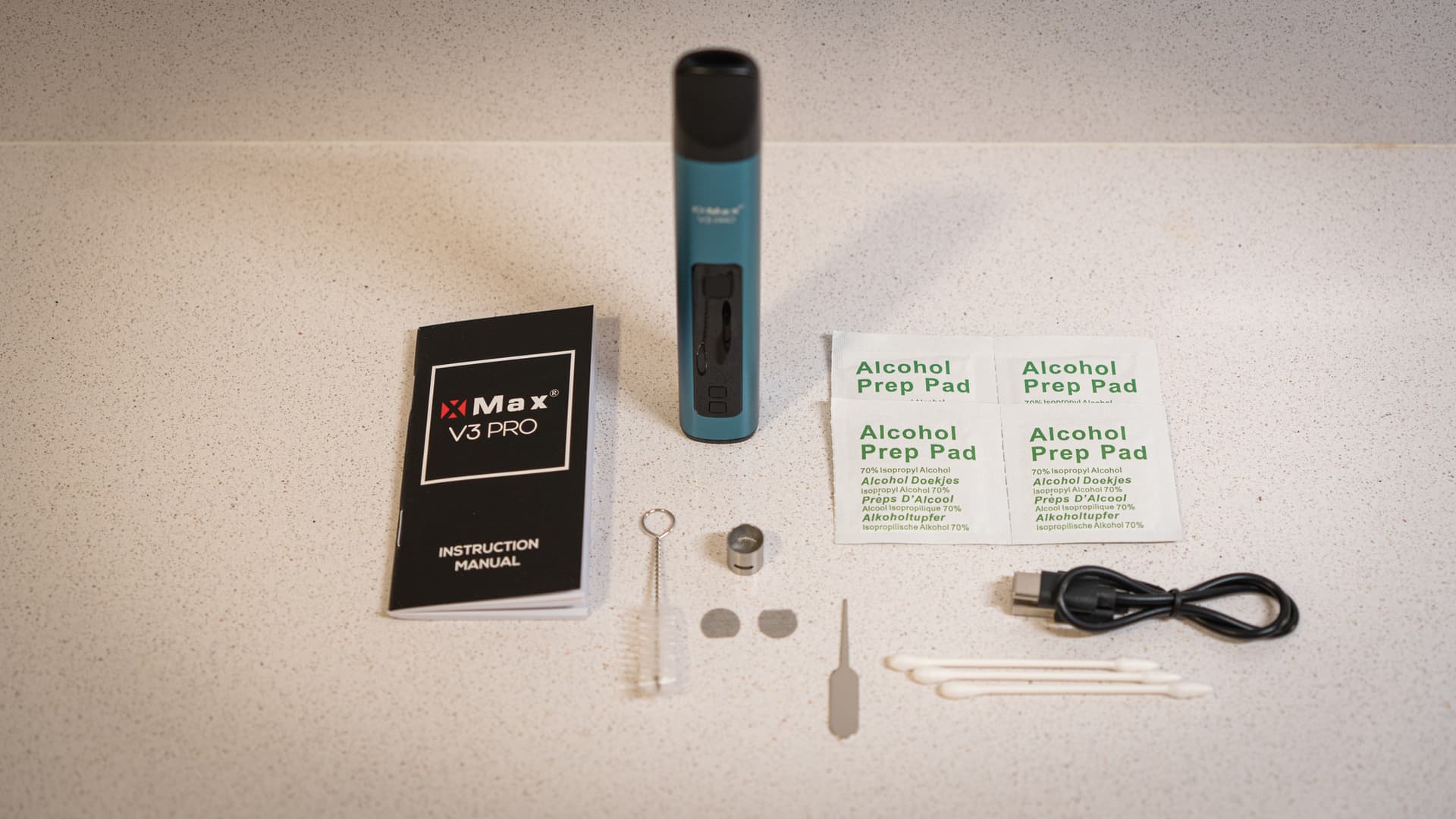 XMax V3 Pro Unboxing-Kit mit türkisem Vaporizer, USB-C-Kabel, Alkoholpads und Reinigungszubehör