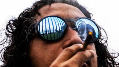 Hemant Shahi smokes marijuana during a rally with cannabis activists outside the White House in Washington on Monday, Oct. 24, 2022. | Tom Williams/CQ Roll Call/Newscom