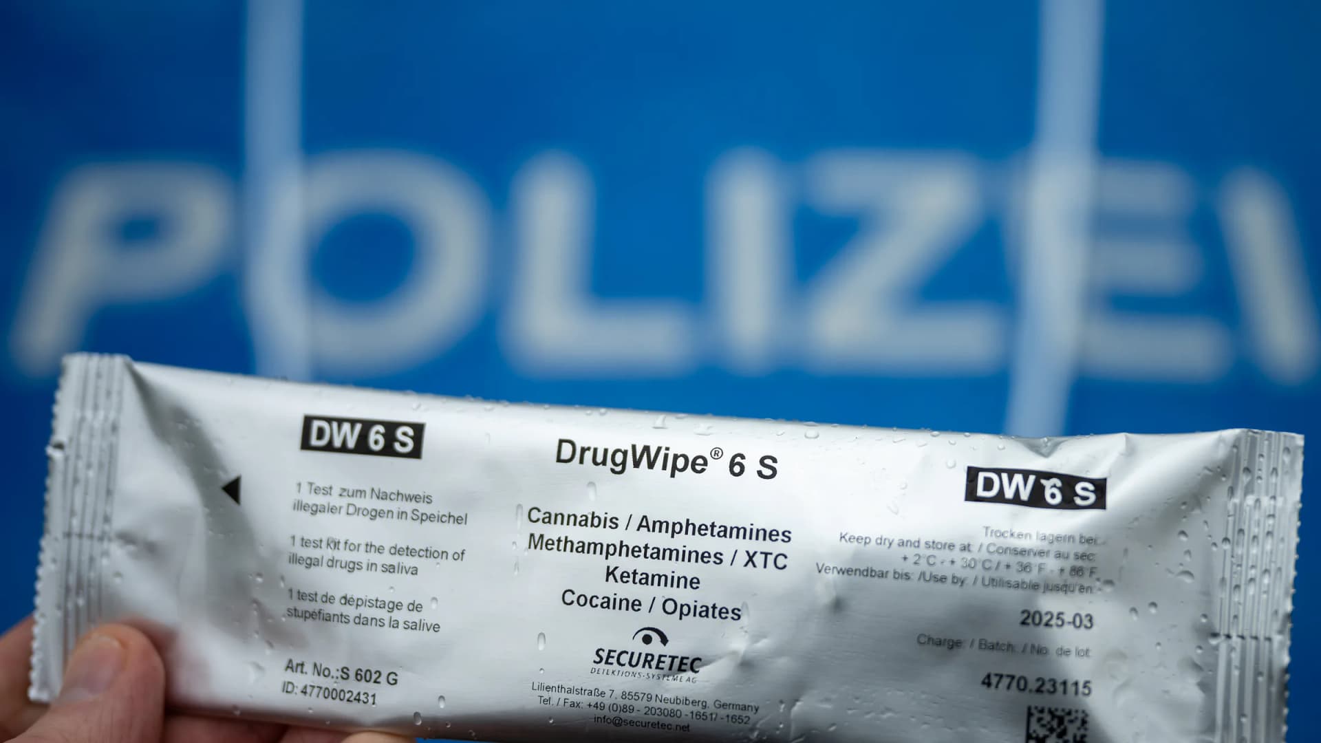 A police officer holds a "DrugWipe 6 S" test kit used to screen road users for cannabis, amphetamines, XTC, ketamine, cocaine and opiates during a traffic stop on Berliner Straße in Trebbin, Brandenburg, Germany, on Friday, March 22, 2024. | Soeren Stache/dpa/picture-alliance/Newscom