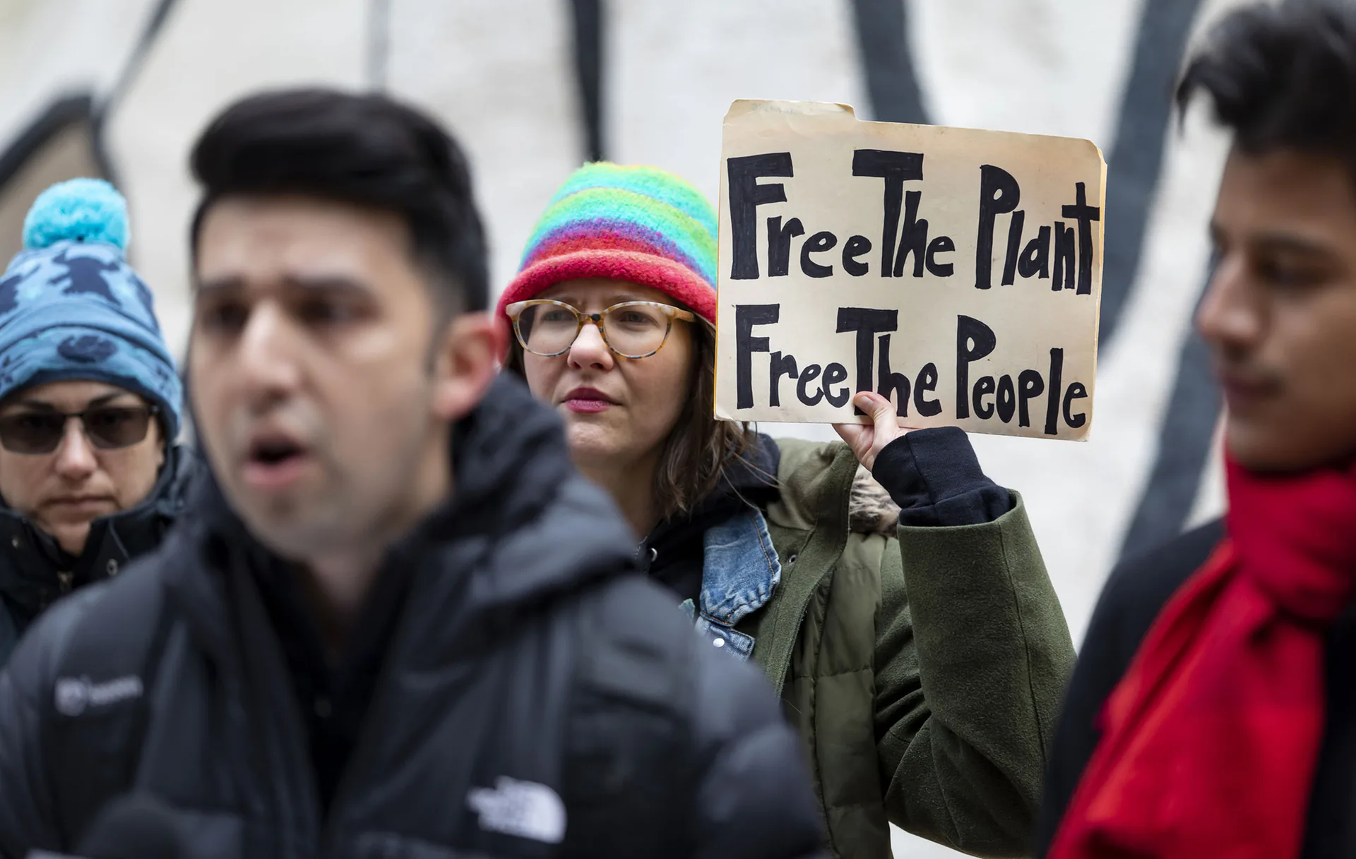 Anna Rose Li-Epstein holds a sign Tuesday, March 29, 2022, during a rally outside the Thompson Center in Chicago organized by the group True Social Equity in Cannabis.
